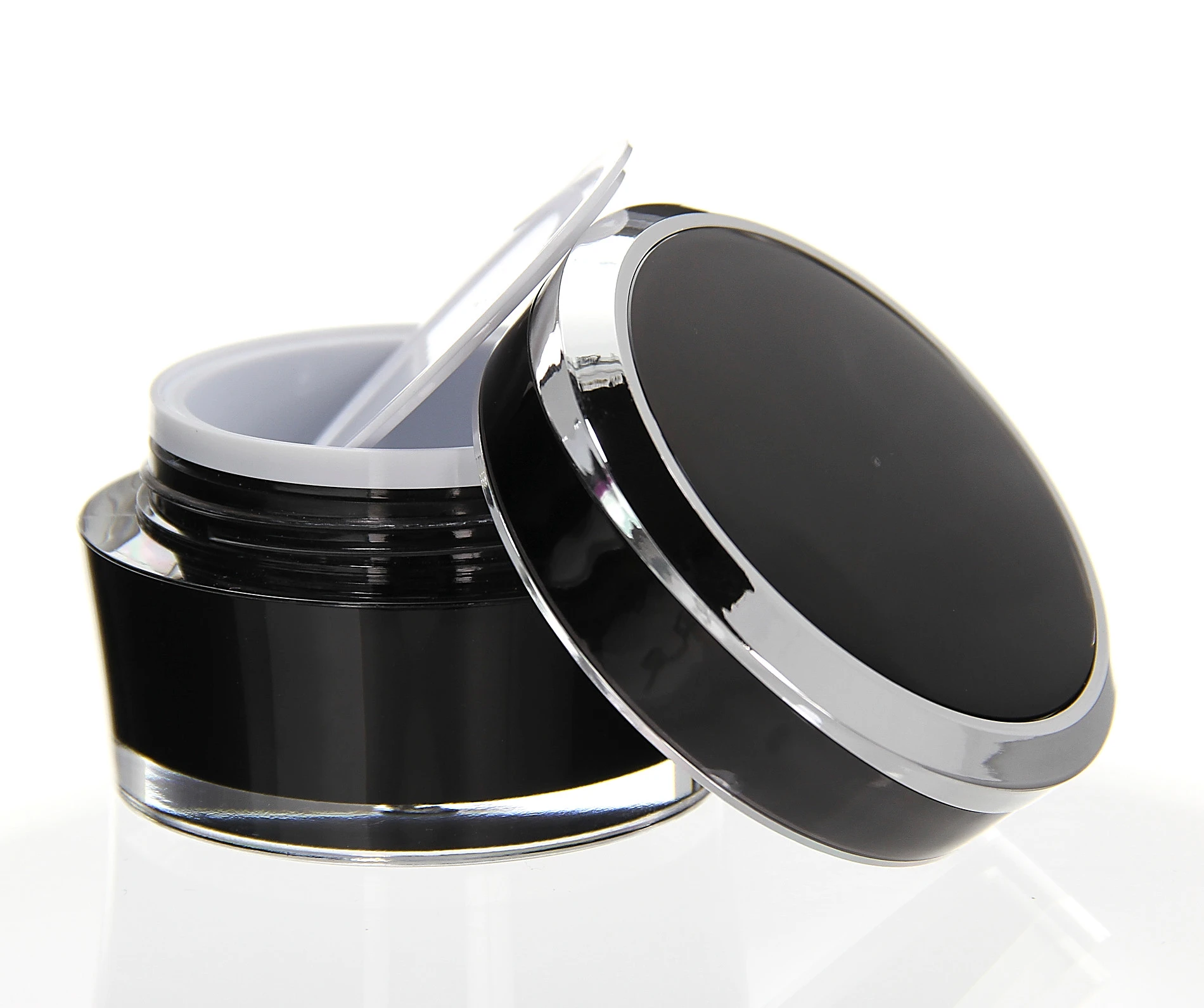 Open 50ml Mars acrylic jar in black with silver lid rim and white sealing disc on light surface