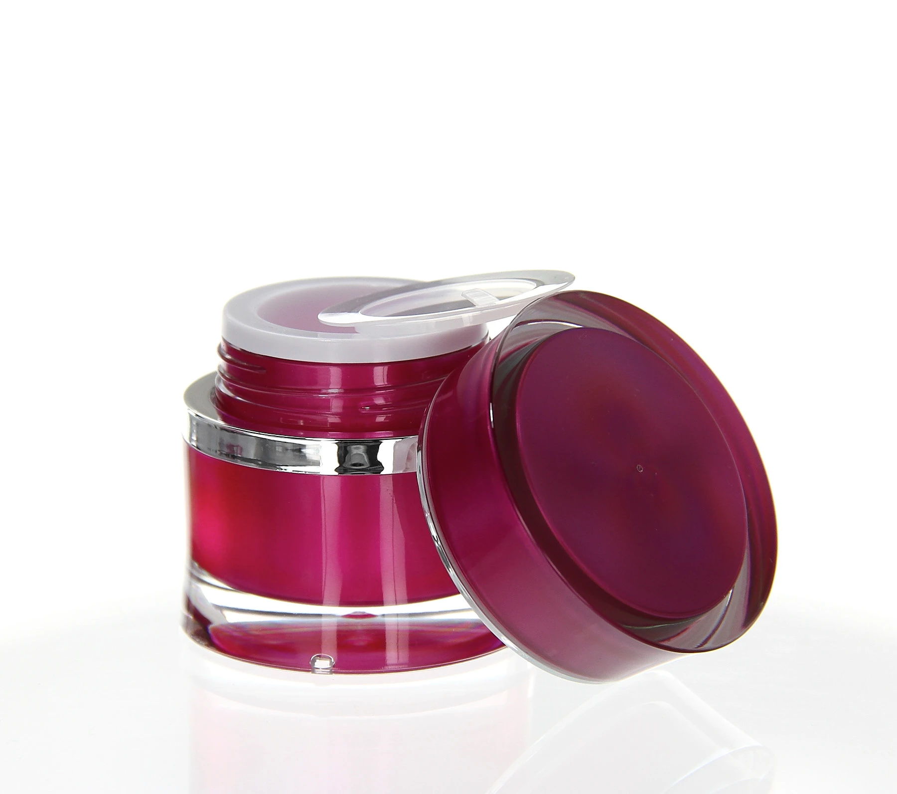 Open 15ml pink acrylic jar with silver ring and transparent inner lid on white background