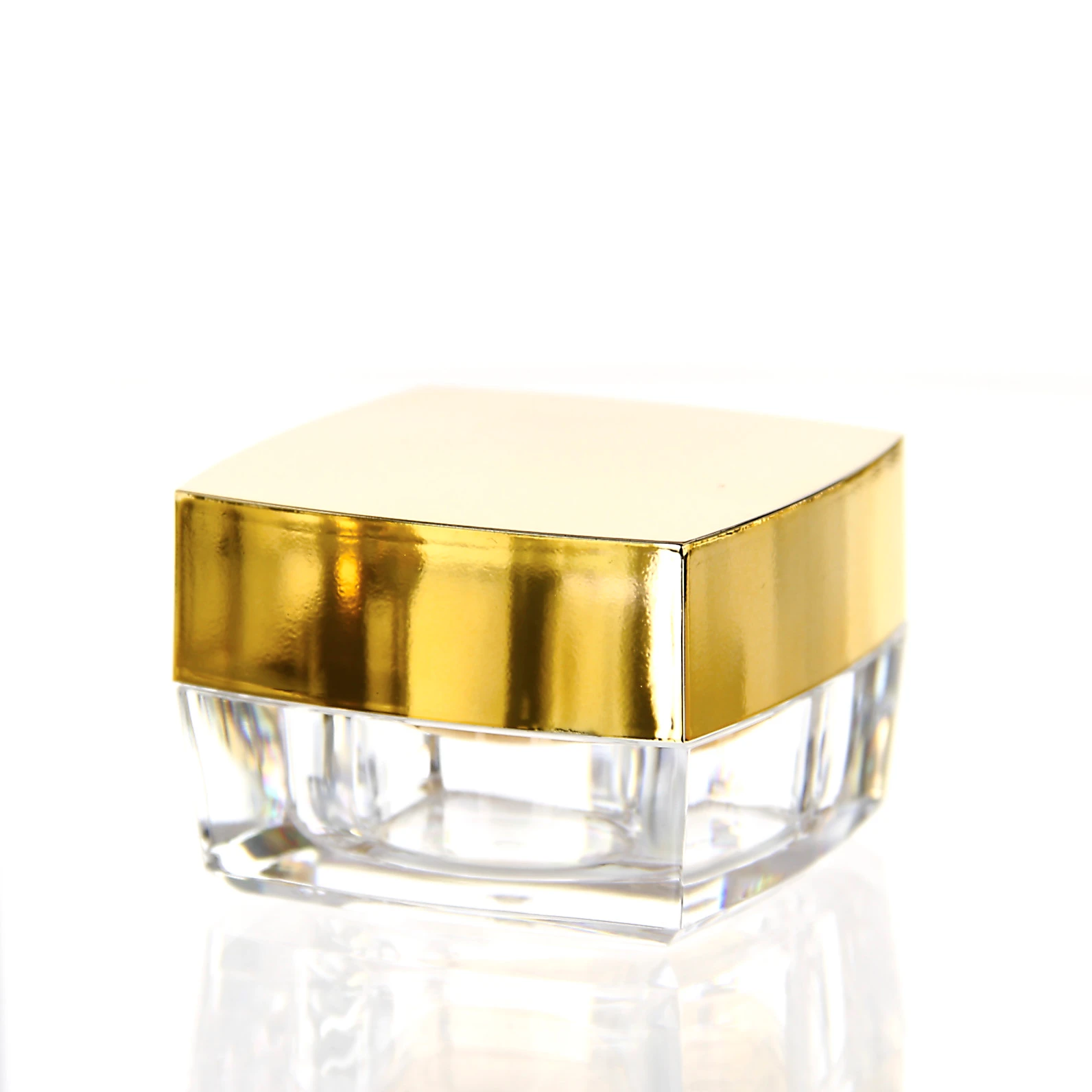 Closed 15ml acrylic jar in glossy gold finish with clear base on light background