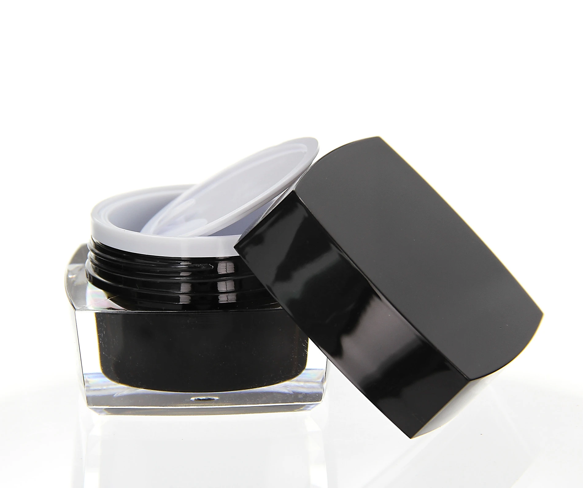 Open 30ml acrylic jar in glossy black with white inner seal and clear base on white background