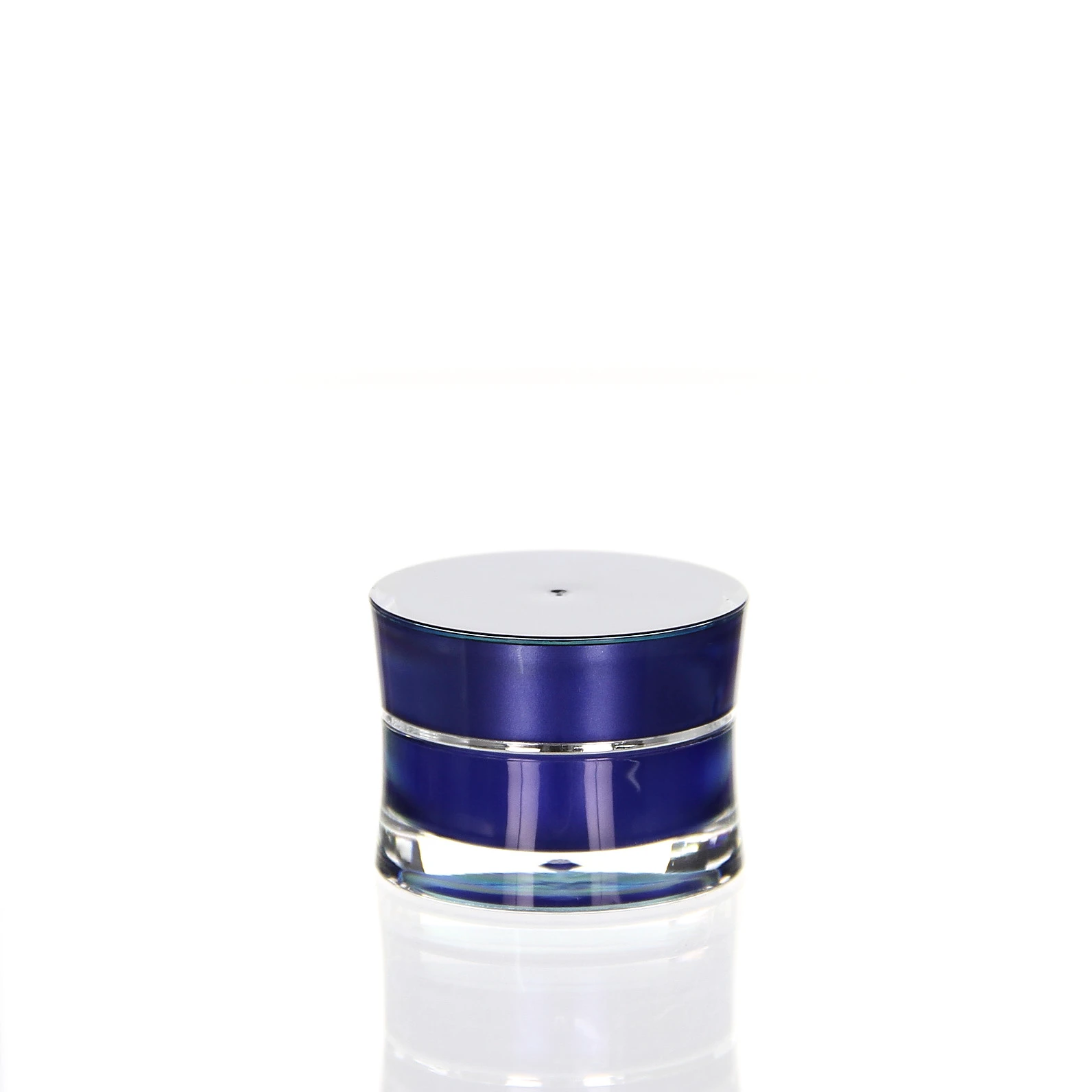 Closed 5ml Ocean acrylic jar in blue with silver lid on light surface