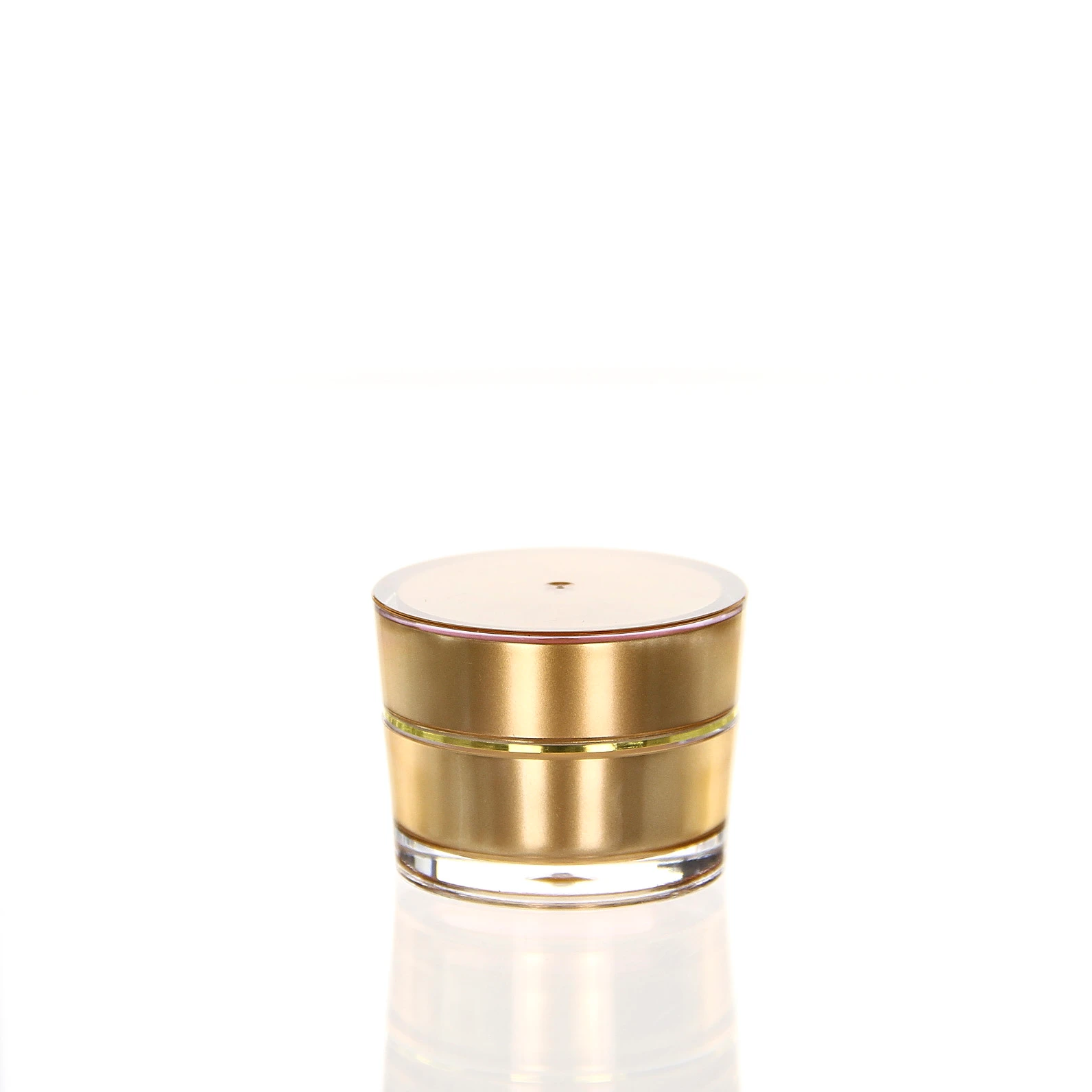 5ml gold acrylic jar for exclusive cosmetic samples and skincare Closed 5ml acrylic jar in glossy gold with transparent double wall on light pedestal