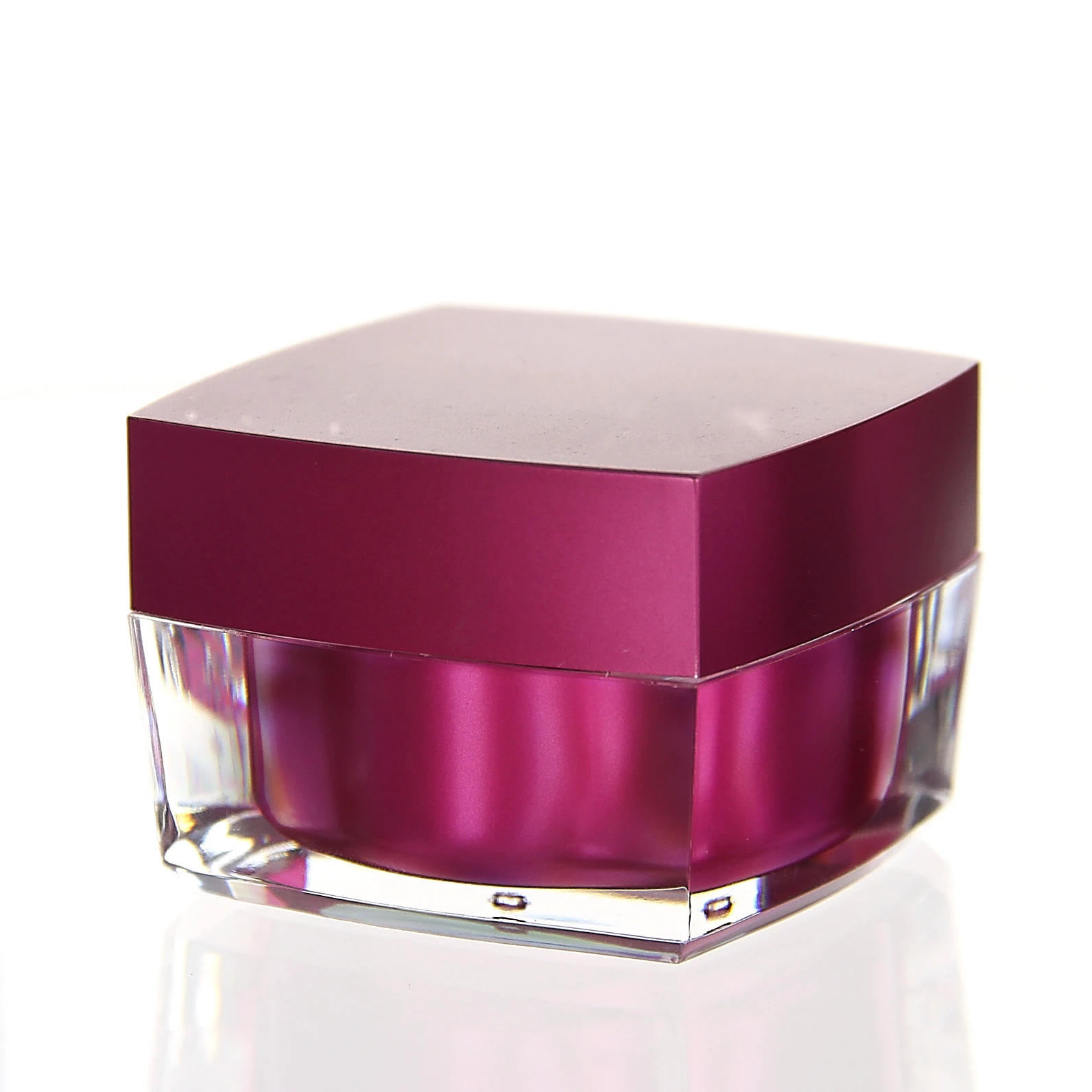Closed 50ml cosmetic jar in glossy pink with clear acrylic outer shell on white background