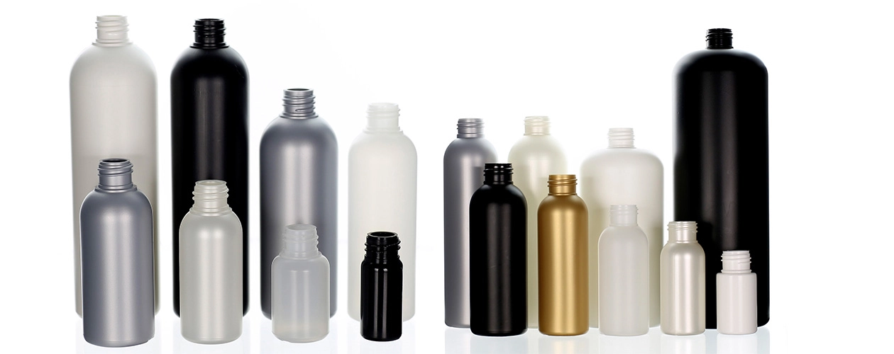 Empty plastic bottles in black, white, gold, and silver in assorted shapes and sizes