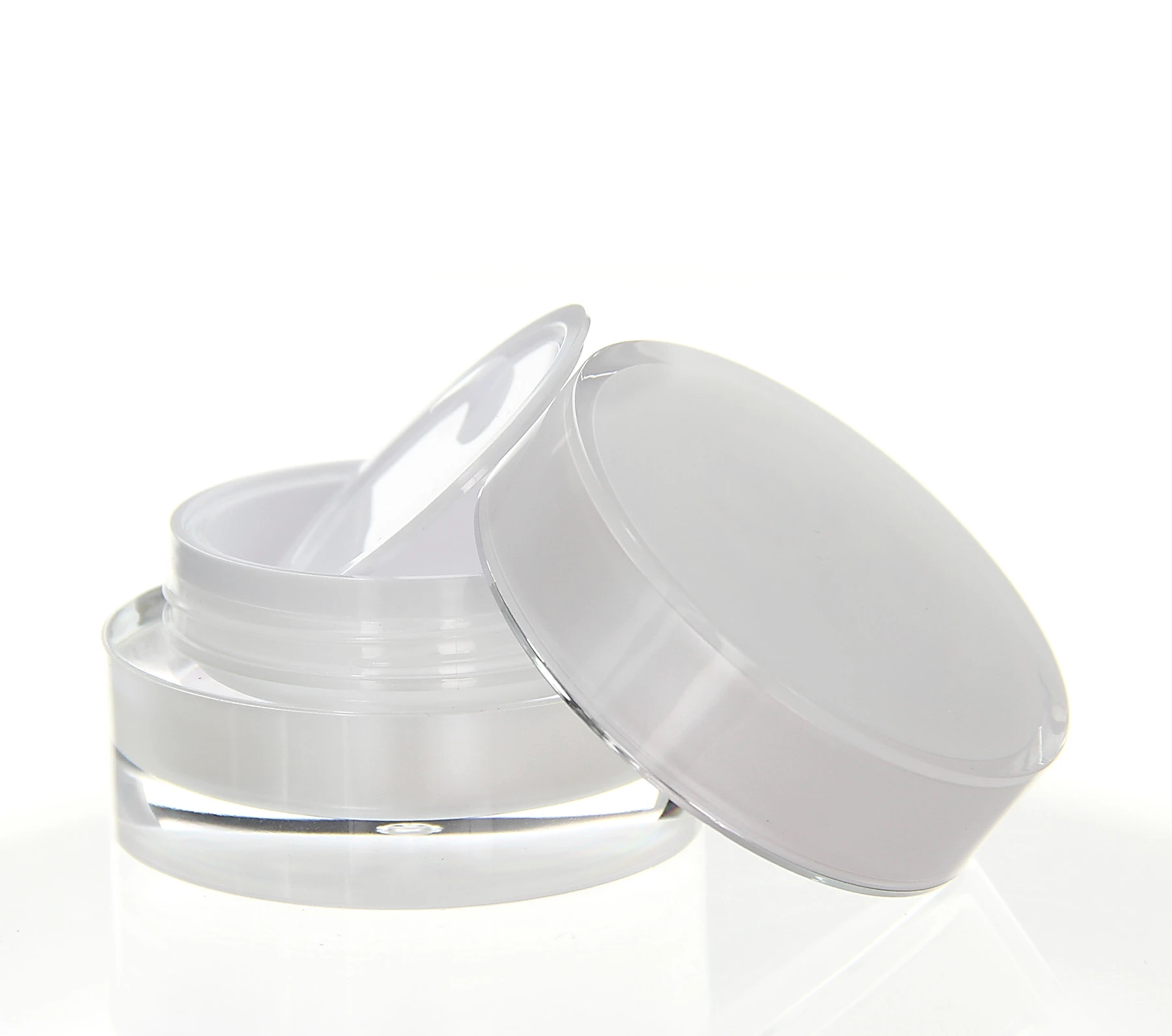 Opened 15ml acrylic jar in pearlescent design with white inner lid on bright surface