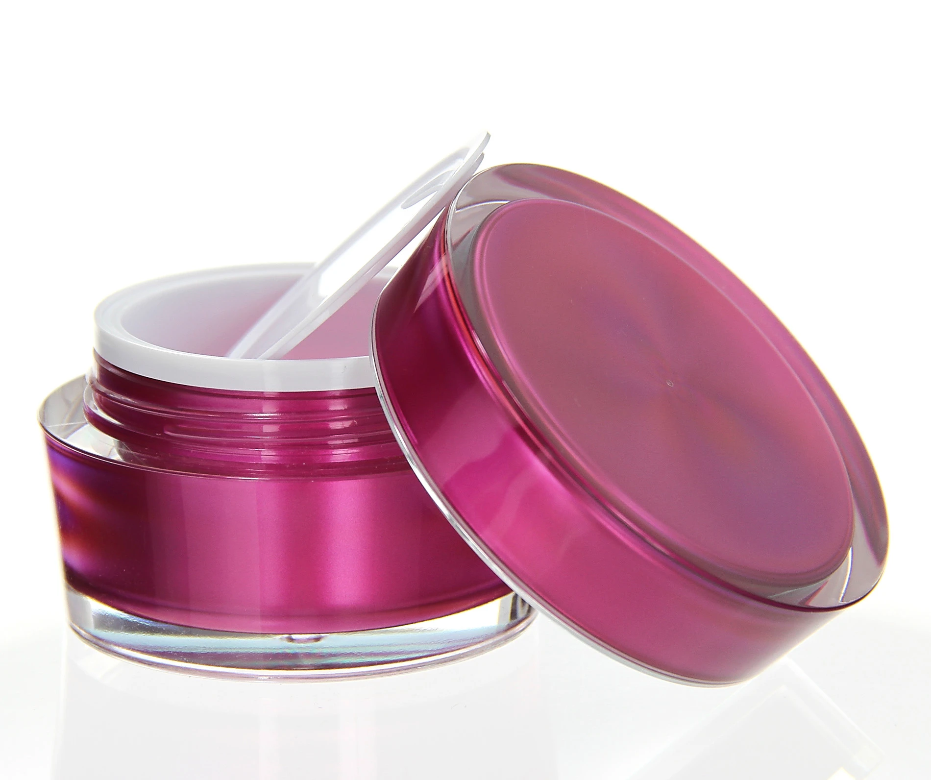 Opened 50ml acrylic jar in glossy pink with lid and sealing disc on white surface