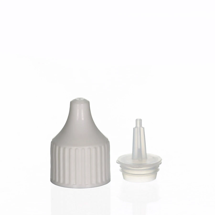 White plastic cap with ribbed surface and separate applicator tip on white background