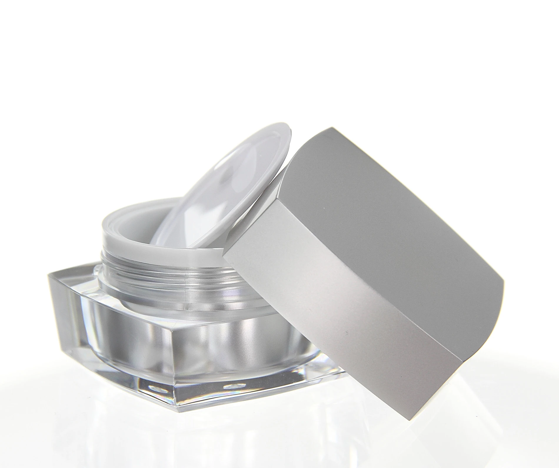 Open 15ml acrylic jar in glossy silver with white inner seal and clear base on light background